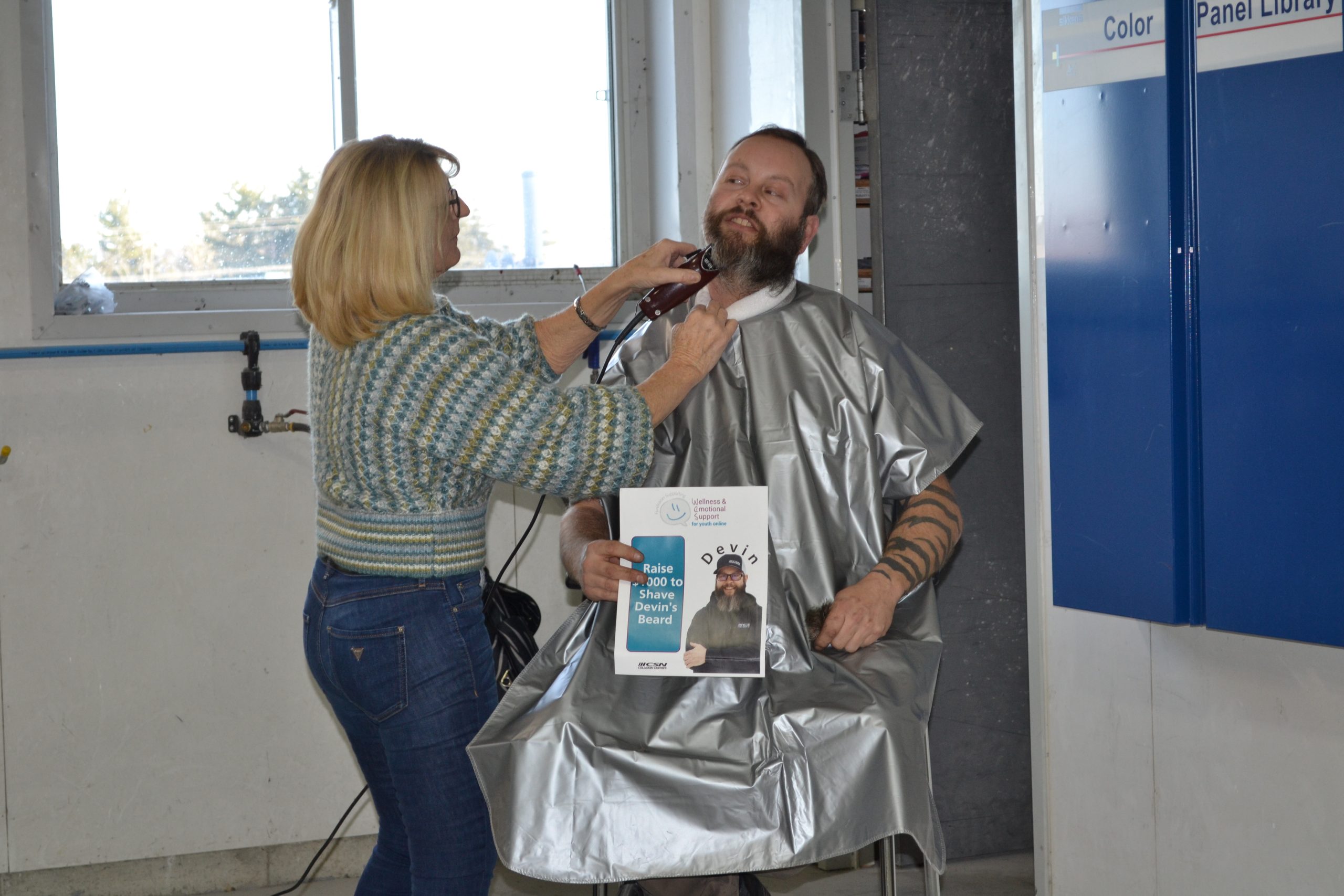 The CSN garage becomes a barber shop as Devin Heuser says goodbye to his beard for charity on Dec. 21, 2022. (Emily Bowen photo)