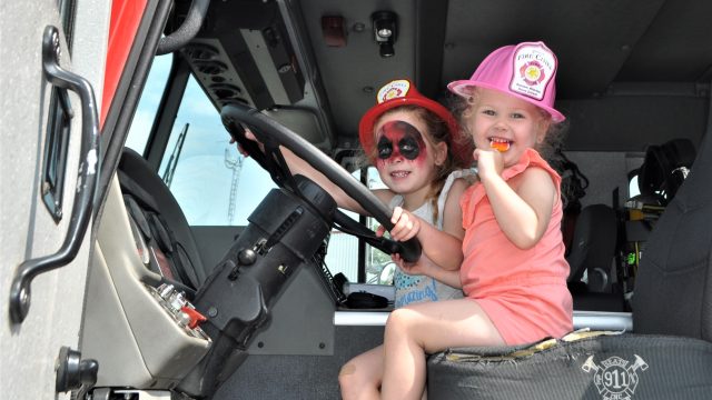 Everleigh and Lylah Spahr get behind the wheel of one of the massive fire trucks on display during the June 6 Walkerton Fire Department touch-a-truck event. How much more fun could an event be? (Pauline Kerr photo)