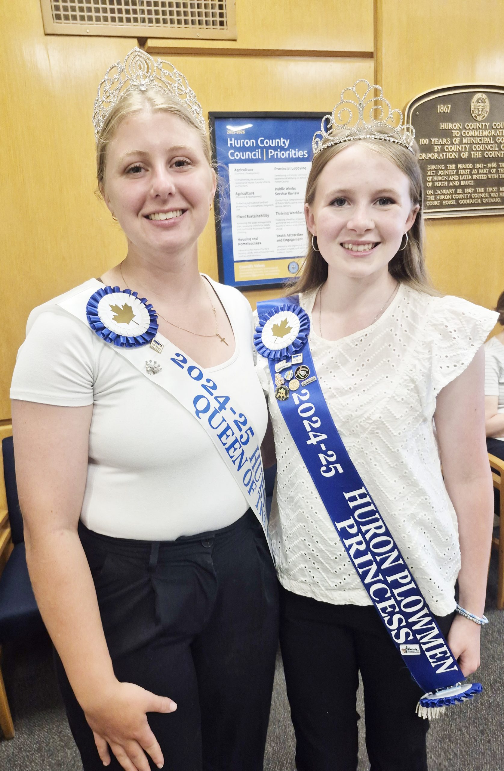 The 2024 Huron County Queen of the Furrow Mackenzie Terpstra, left, and Huron County Plowing Match Princess Jillian Simpson, right, attended Huron County Council’s July 2 meeting to tell council members about themselves, their activities and their future plans.